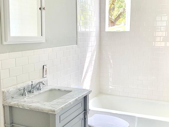 Updated bath with tub shower combo , tile and cabinet with storage ( washer dryer included )