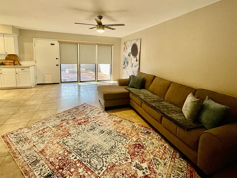 family room off kitchen with large windows looking into backyard