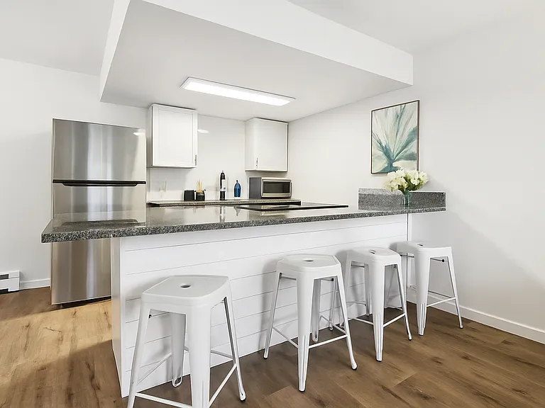 This kitchen invites you to gather, chat, and enjoy casual meals in a fresh, open setting.