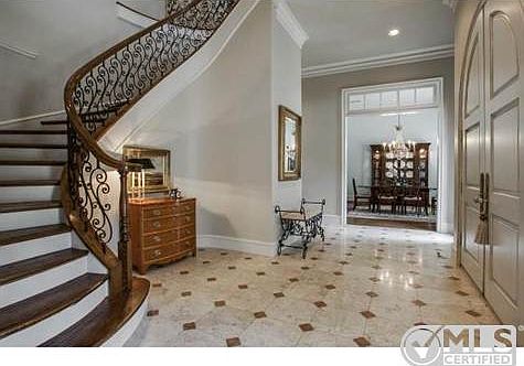Custom iron baluster staircase with wood stairs and abundant cro