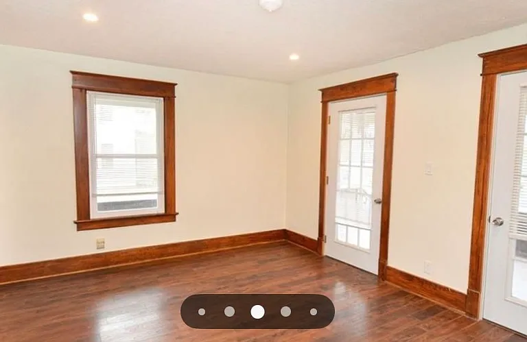living room looking towards front porch, two doors enter onto front porch.