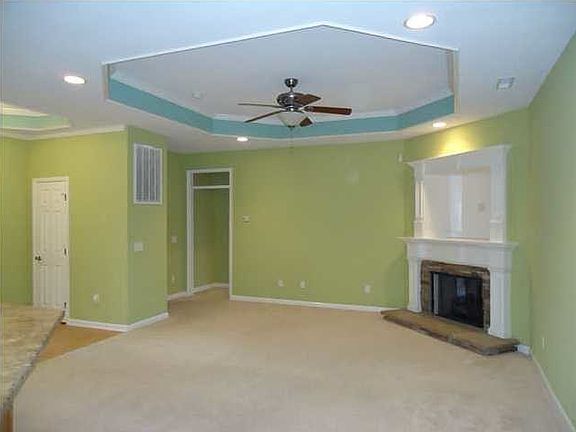 Family room with gas log fire place with stone accents
