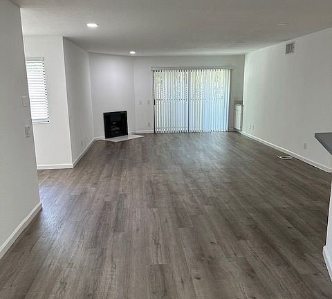 Large, spacious living room with working fireplace and wet bar for entertaining.