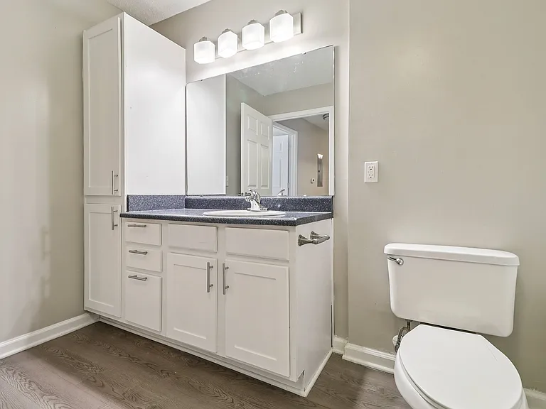 Convenient bathrooms include vanity cabinets for storage and large mirrors, professionally operated by Highlands Vista Group.