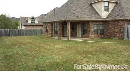 Fenced backyard
						:
						Showing covered patio and "shadowbox" style wood fence