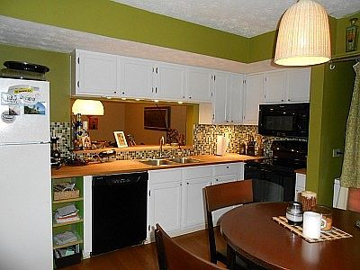 White kitchen, tile backsplash, open to living area