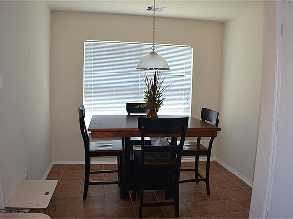 Dining area with views of large backyard.