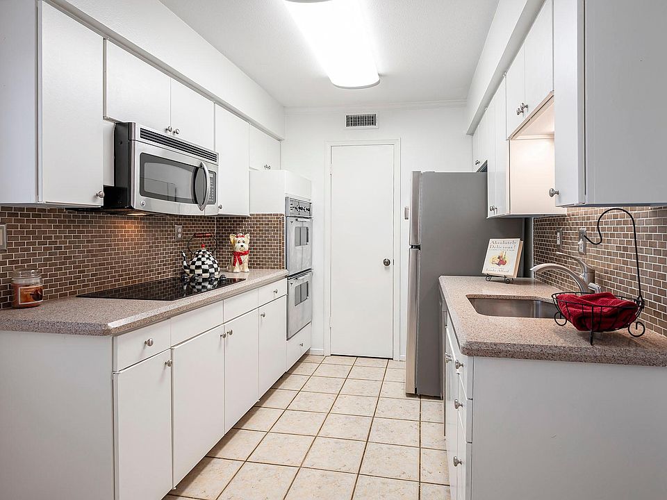 Large kitchen with ceramic cook top, built-in microwave, double ovens, plenty of counter space and a large pantry