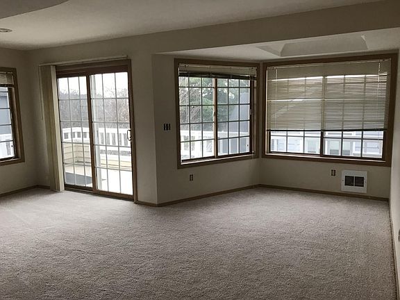 Lots of natural light, warm wood window trim, and wrap around deck.