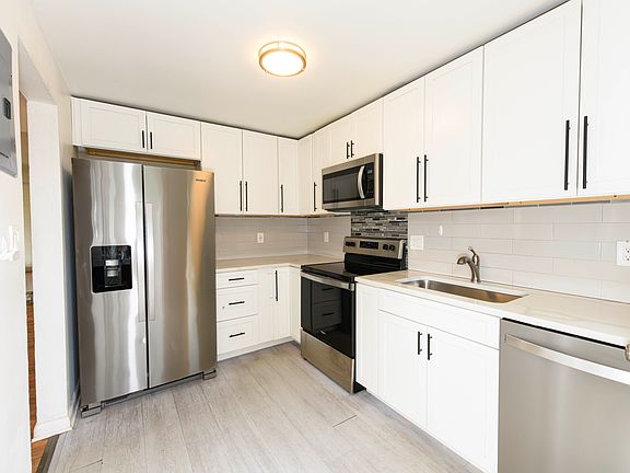 Full kitchen upstairs with updated stainless steel appliances.
