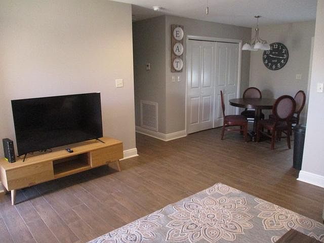 Living room with TV and Dining area. Washer & Dryer in large utility room