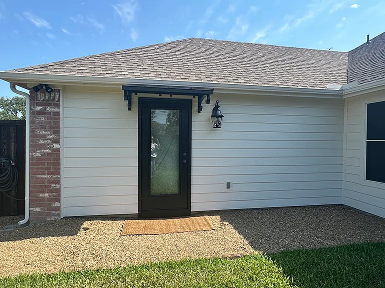 High security garage entry door equipped with sliding screen door and blind rod for room darkening.