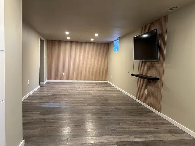 Large front entry/living/dining space with entertainment center.