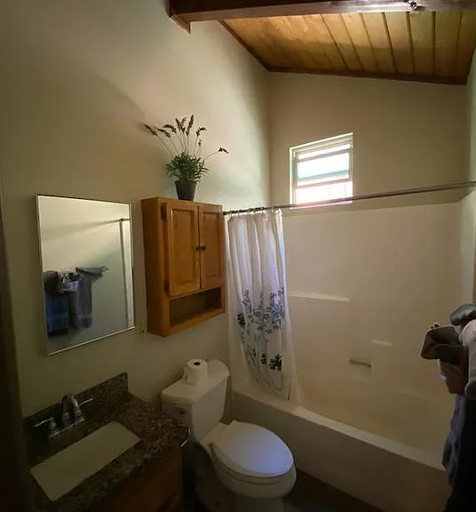 Full bathroom with high open beam ceilings and full size bathtub 4 a nice mountain soak. Newer granite counter and faucets.