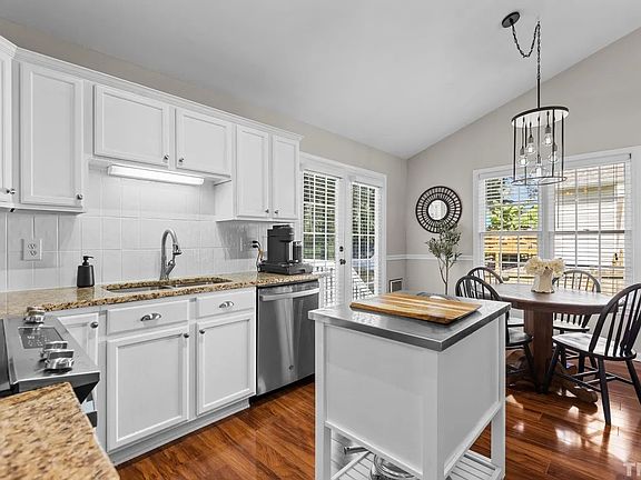 Beautiful natural light fills the dining area next to kitchen with updated appliances.
