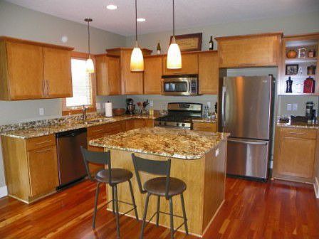 Kitchen - Granite countertops, cherry hardwood floors and stainless steel appliances.