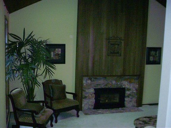 living room with vaulted ceilings and gas fireplace