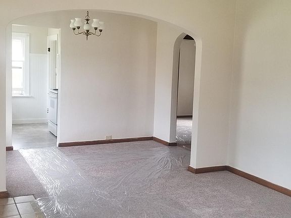 Living room, looking into dining room, kitchen and hallway to bedrooms and bath