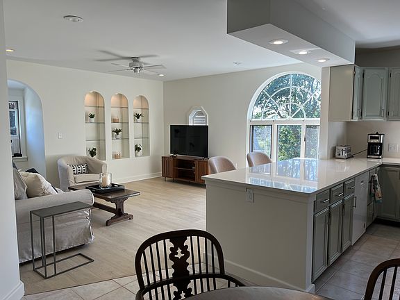 Spacious and sunny, open concept living/dining/kitchen also has island countertop with two swivel stools. New luxury wood vinyl floors in living room and bedrooms.