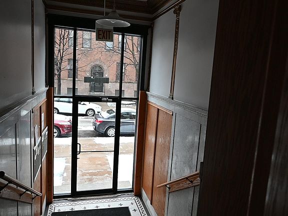 View out toward street from inside building foyer