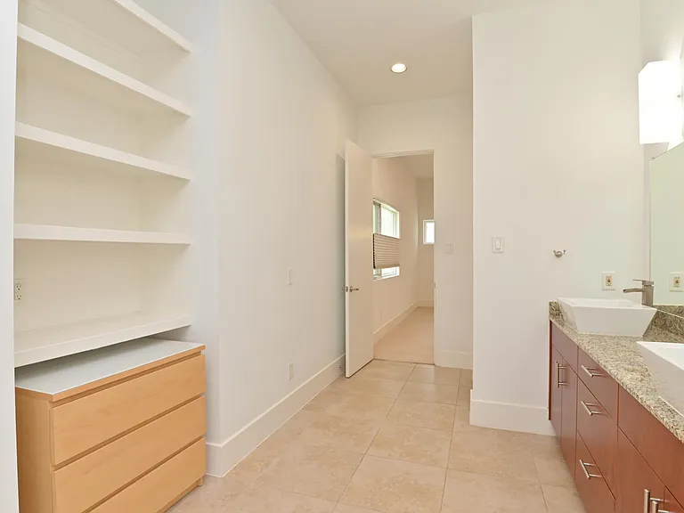 Large master en suite features custom cabinetry.