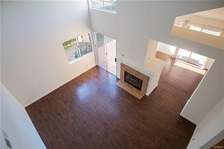 Welcome to a light & bright residence with soaring ceilings and gas fireplace.