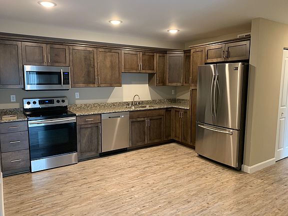 Custom cabinetry, Samsung Stainless Steel appliances with granite counter tops and LED lighting