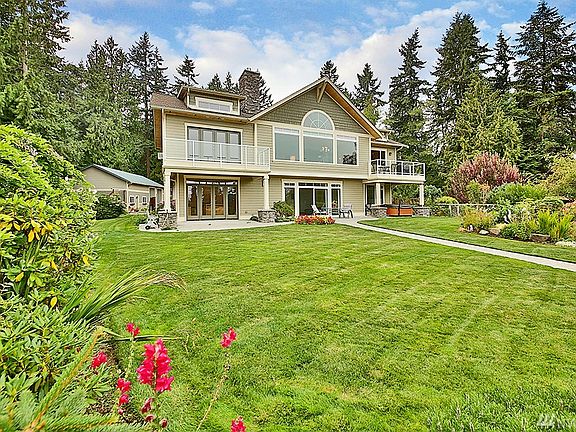 Amazing gardens with lush mature landscaping and surrounded by towering evergreens and open space!