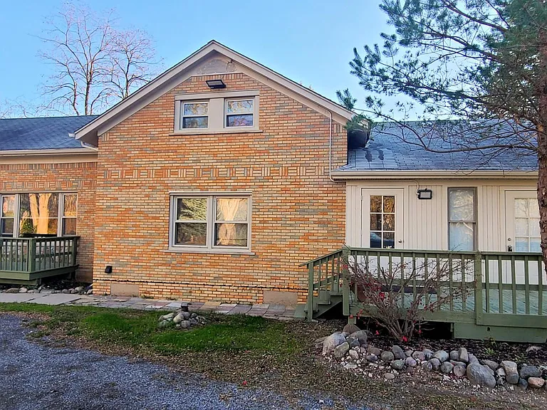 The home is a multi-unit property. This apartment is on the left side of this photo with the large window and deck.
