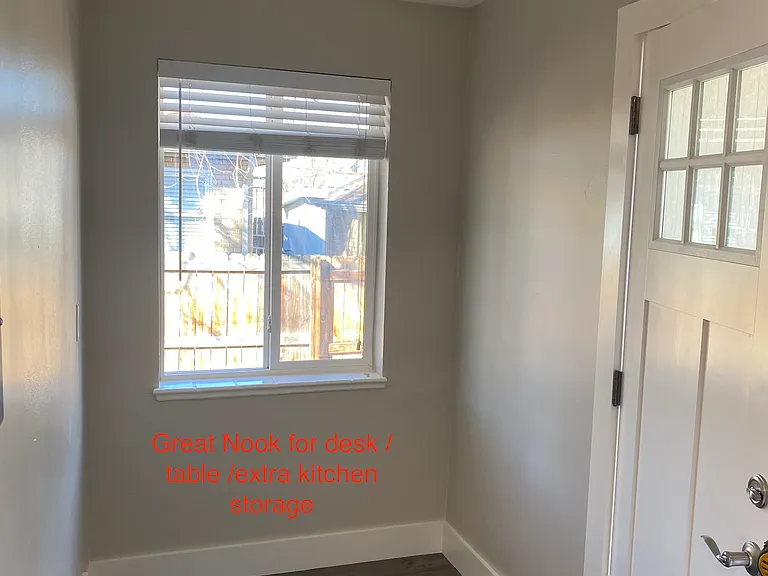 Kitchen nook by back door which opens to the private back yard area. The nook is large enough for a good size desk, table or kitchen storage piece.