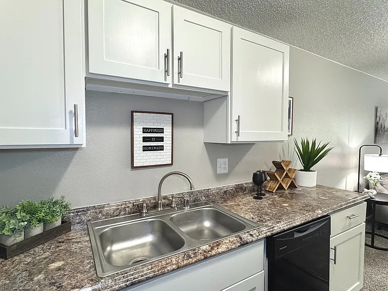 Cook up your favorite meals in a kitchen that's as stylish as it is functional, complete with sleek, black appliances.