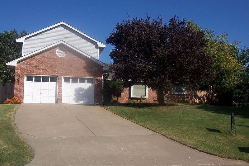 Home is located in a cul-de sac, large plum tree in front.