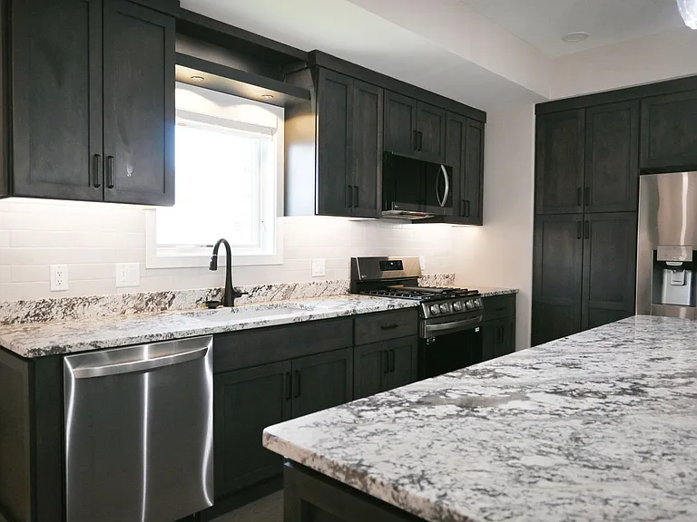 Kitchen island and luxury finishes in a kitchen at Lyric Townhomes.