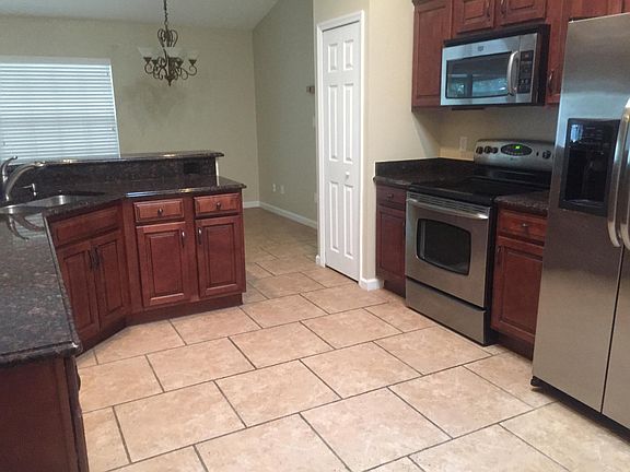 Kitchen with granite counters, solid wood cabinets, and stainless steel appliances