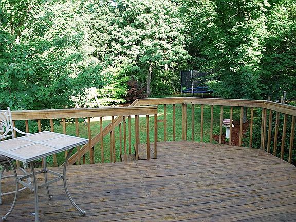 Deck overlooking fenced backyard