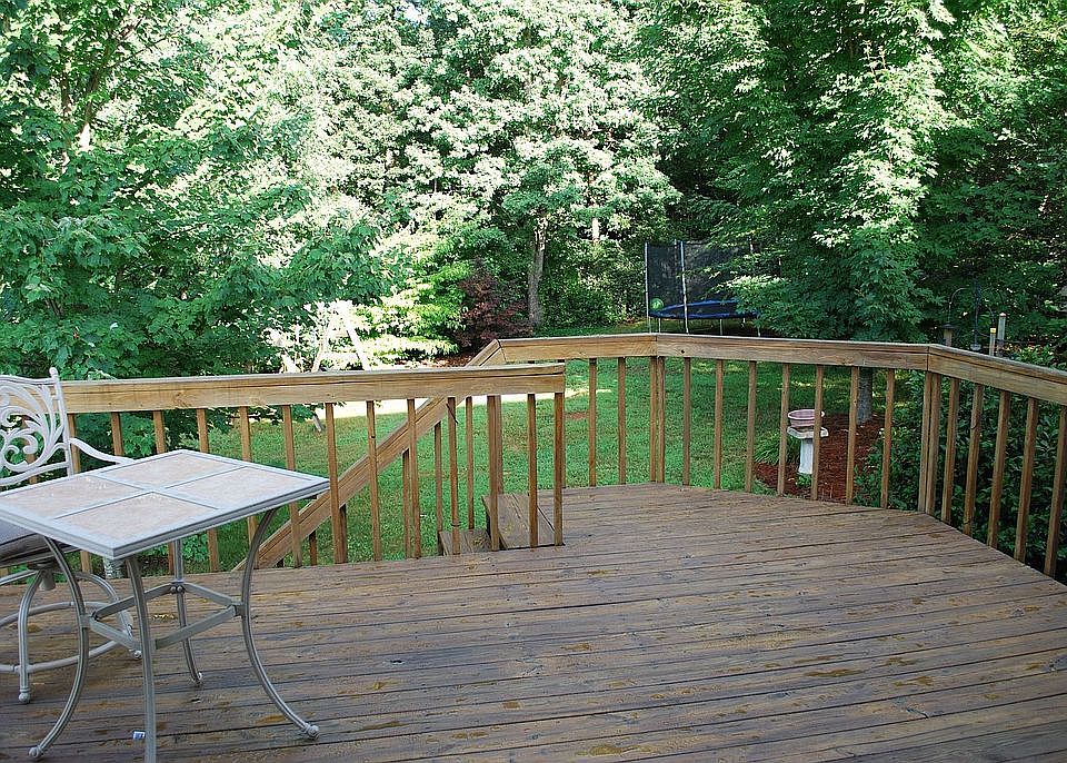 Deck overlooking fenced backyard