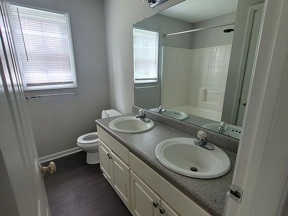 Primary bathroom with dual sinks and deep soaker tub.