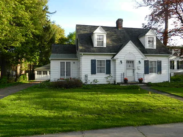 Front yard with garage to left