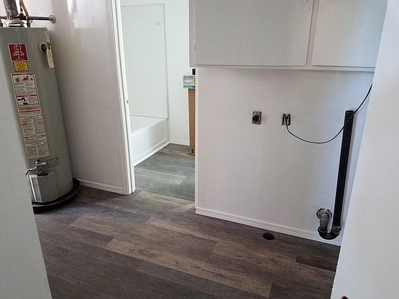 washroom with door to bathroom and door to outside.