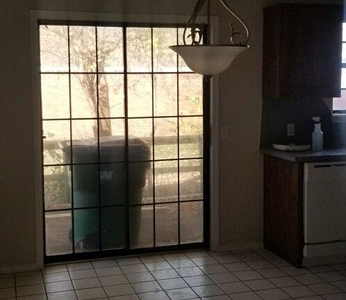 View of dining area with kitchen to right.