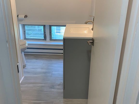 Newly remodeled bathroom with new vanity, flooring, toilet and shower valve/faucet