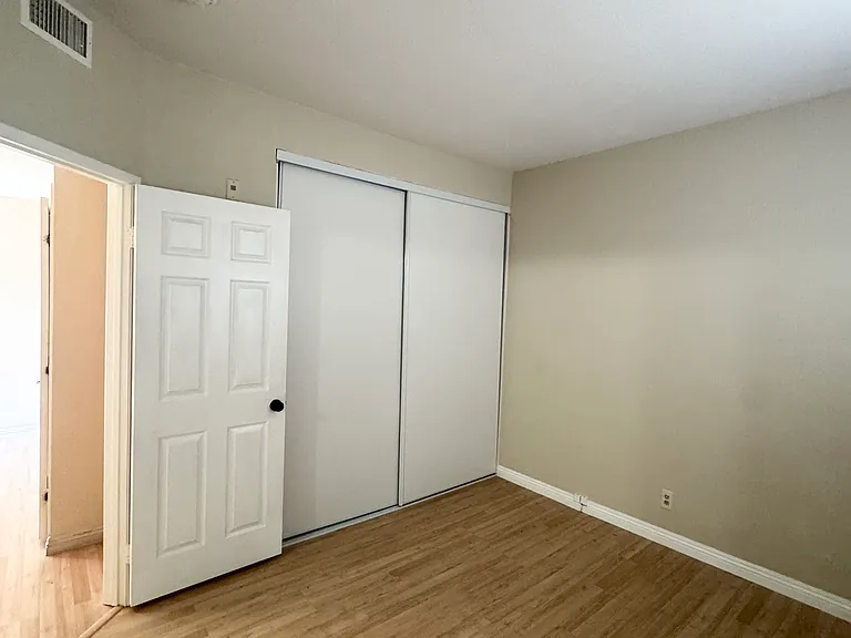 Bedroom 1 features laminate flooring