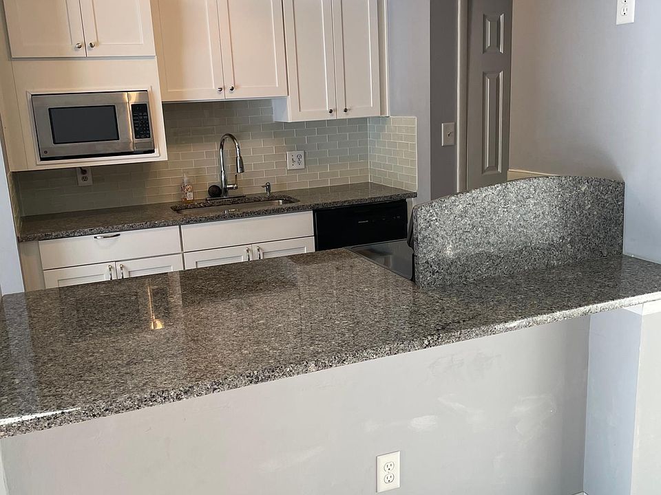 Updated Kitchen with Glass tile Back splash With Granite Counters and Breakfast Nook.