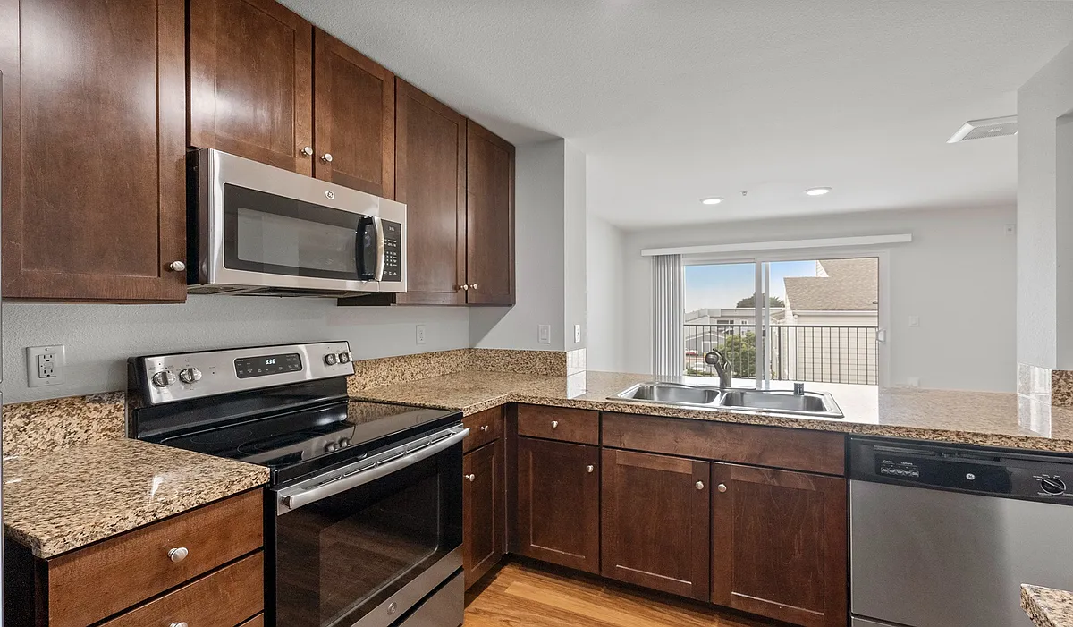 Kitchens feature granite countertops and offer a separate dining area to enjoy your meals - Pacific Bay Vistas
