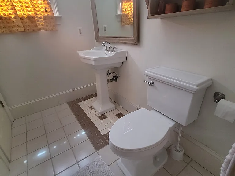 Tiled bright airy bathroom. With window facing South.