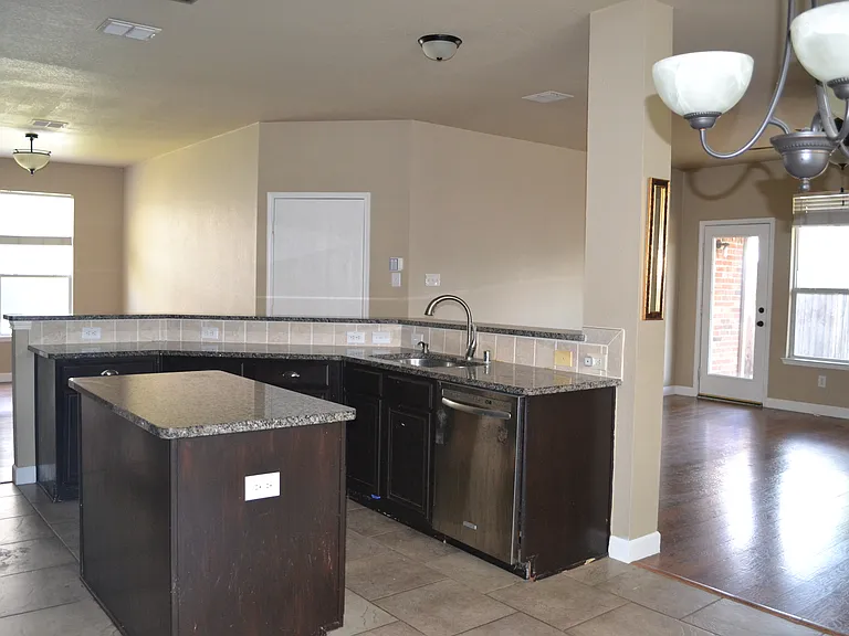 Kitchen looking at formal dining and family room.