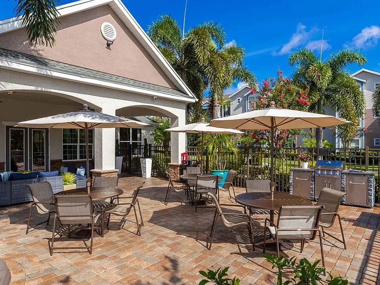 Fire up the grill and gather around with friends in this beautifully designed poolside barbecue area.