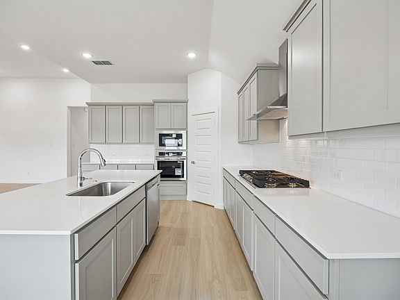 Kitchen in the Gilmour II home plan by Trophy Signature Homes - REPRESENTATIVE PHOTO