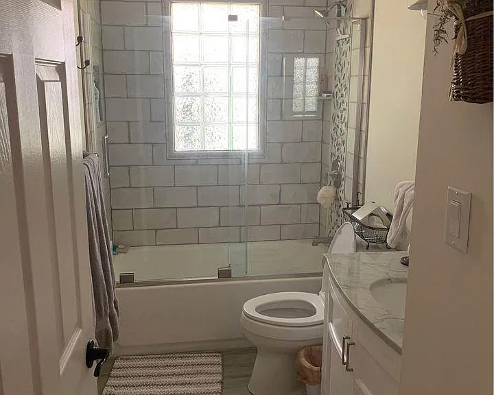 Renovated bathroom with tub and shower