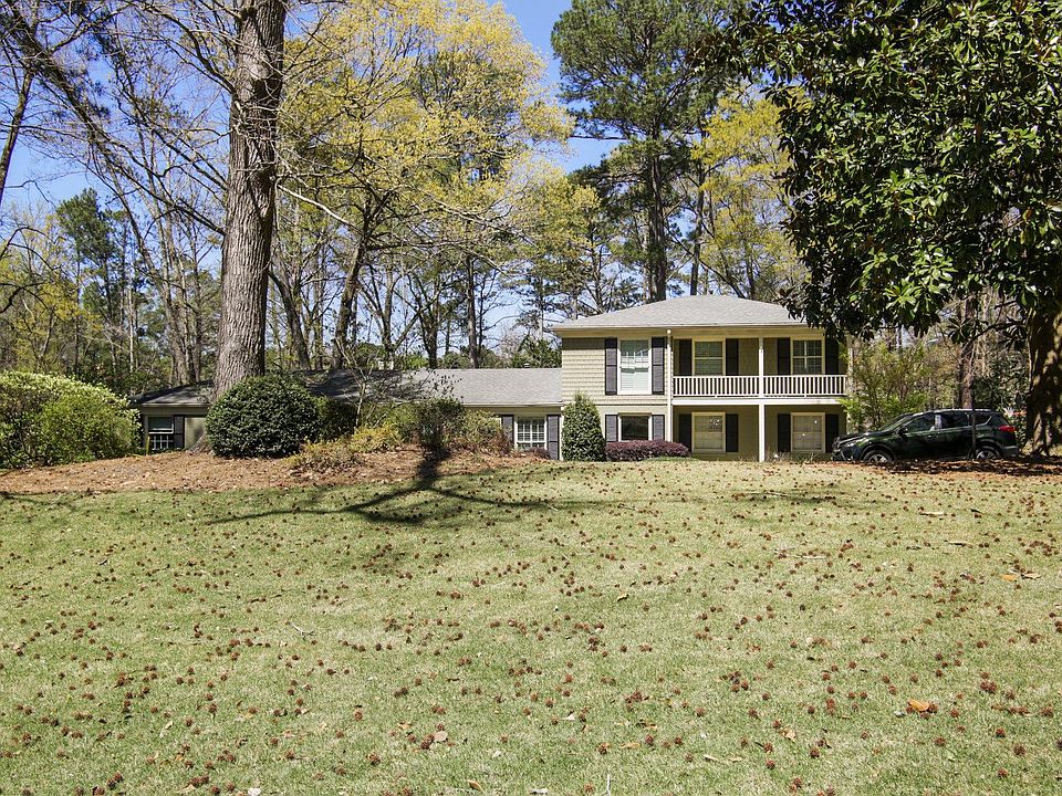 Front exterior from the street of this 1+ acre private property with mature landscaping (azaleas, hydrangeas, dogwoods, large trees) on quiet street.